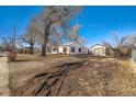 A single Gathering home sits on a large lot with a detached garage and mature trees at 315 Depew St, Lakewood, CO 80226