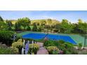 Beautifully landscaped tennis court featuring shaded benches, and manicured flower beds with a scenic backdrop at 8000 N 41St St, Longmont, CO 80503