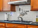 Close up of kitchen with stainless steel appliances and custom cabinetry at 4348 Umatilla St, Denver, CO 80211