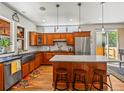 Spacious kitchen with custom cabinets, stainless appliances, and center island with seating at 4348 Umatilla St, Denver, CO 80211