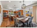 Spacious eat-in kitchen with stainless steel appliances, wood cabinets and a dining area at 4348 Umatilla St, Denver, CO 80211