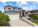 Beautifully landscaped two-story home with a well-maintained lawn and a two-car garage at 8261 Garden City Ave, Littleton, CO 80125