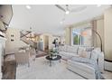 Bright and open living room featuring modern furnishings and a seamless flow to the dining area at 8261 Garden City Ave, Littleton, CO 80125