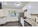 Updated kitchen with stainless steel appliances, granite countertops, and a window at 5712 S Lowell Blvd, Littleton, CO 80123
