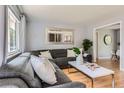 Bright living room with a comfortable sectional sofa, modern decor, and a large mirror at 13483 Achilles Dr, Lone Tree, CO 80124