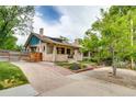 Exterior view showcasing the brick facade, driveway, and landscaped front yard at 3525 N Alcott St, Denver, CO 80211