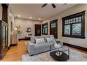 Bright living room with hardwood floors, gray couch, and neutral decor at 3525 N Alcott St, Denver, CO 80211