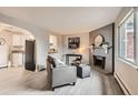 Inviting living room featuring a brick fireplace, gray sofa, and stylish decor at 5491 E Warren Ave # 224, Denver, CO 80222