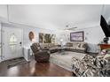 Spacious living room with hardwood floors, modern ceiling fan, and large window for ample natural light at 8871 Rutgers St, Westminster, CO 80031