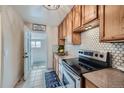 Charming kitchen with wooden cabinets, tile backsplash, and modern appliances at 710 E Alameda Ave, Denver, CO 80209