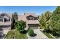 Attractive two-story home with lush landscaping, a driveway, and an attached two-car garage at 9255 Melborne Ct, Parker, CO 80134