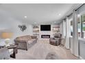 Cozy living room with a modern fireplace, stylish decor, and plenty of natural light at 9880 E 157Th Ave, Brighton, CO 80602