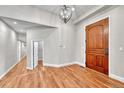 Bright foyer with hardwood floors, modern lighting, and a glimpse of the home's interior layout at 5255 Ridge Trl, Littleton, CO 80123