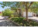 Charming home boasts a welcoming front porch, a lush lawn, and a spacious two-car garage at 19560 E 18Th Pl, Aurora, CO 80011