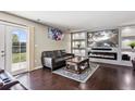 Modern living room with stylish fireplace, mounted TV, and contemporary decor at 19560 E 18Th Pl, Aurora, CO 80011