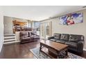 Comfortable living room features hardwood floors, leather seating, and ample natural light at 19560 E 18Th Pl, Aurora, CO 80011