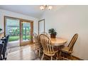 Cozy dining area featuring wood floors, a table with seating for four, and sliding door access to the backyard at 10602 W Patterson Pl, Littleton, CO 80127