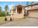 Inviting home featuring a covered entryway with a spacious front yard and attached two-car garage at 2164 Foothills S Dr, Golden, CO 80401