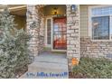 Inviting front entrance with stone accents and a red door at 4508 E Louisiana Ave, Denver, CO 80246