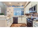 Modern kitchen with white cabinets, granite counters, and stainless steel appliances at 4508 E Louisiana Ave, Denver, CO 80246