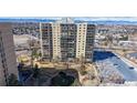 Modern apartment building with large windows and a meticulously landscaped courtyard and fountain at 7865 E Mississippi Ave # 702, Denver, CO 80247