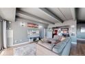 Comfortable living room with a large sectional sofa, flat-screen TV, and modern decor at 7865 E Mississippi Ave # 702, Denver, CO 80247