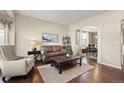Cozy living room with plush seating and elegant archway to dining room at 5128 Longs Peak St, Brighton, CO 80601