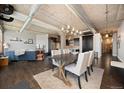 Bright living room with exposed ductwork, modern lighting, and open floor plan to the kitchen and dining area at 1301 Wazee St # 3C, Denver, CO 80204