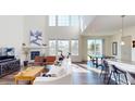 Bright living room with fireplace, large windows, and open floor plan at 3062 Grizzly Peak Dr, Broomfield, CO 80023