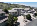 Stunning aerial view of a luxurious home with a tile roof and a large driveway at 6405 Eagle Feather Trl, Littleton, CO 80125