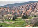 Picturesque golf course with beautiful red rocks in the background creating a great view at 6405 Eagle Feather Trl, Littleton, CO 80125