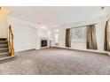 Bright living room with neutral carpet, fireplace, archways, and natural light at 371 Granby Way # C, Aurora, CO 80011
