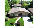 Aerial view of a well-maintained home, mature trees, and a lush green lawn with inviting curb appeal at 6630 E Virginia Ave, Denver, CO 80224