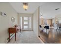 Inviting foyer featuring tiled flooring, decorative console, and an open view to the living and dining areas at 6630 E Virginia Ave, Denver, CO 80224