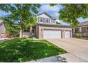 Beautiful two-story home featuring a spacious three car garage and a well-manicured front lawn at 11861 Fairplay St, Commerce City, CO 80603