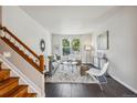 Sun-drenched living room featuring modern decor and an expansive window view at 11716 W Belleview Dr, Littleton, CO 80127