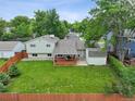 Expansive backyard featuring a wooden deck, lush lawn, shed, and privacy fence for outdoor enjoyment at 9306 Garrison Dr, Broomfield, CO 80021