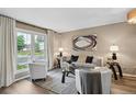 Cozy living room features a large window, neutral decor and lots of natural light at 9306 Garrison Dr, Broomfield, CO 80021