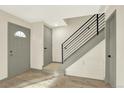 An inviting home entryway featuring hardwood floors and a modern staircase with black metal railings at 12933 E Louisiana Ave, Aurora, CO 80012