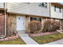 Charming townhouse exterior featuring brick and siding, with a well-manicured walkway to the front door at 12933 E Louisiana Ave, Aurora, CO 80012