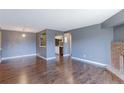 Open-concept living room with hardwood floors, fireplace, and view into the kitchen at 14204 E 1St Dr # A12, Aurora, CO 80011