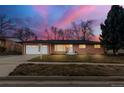 Traditional brick home with a well-manicured lawn, white trim, and a two-car garage at 3565 S Holly St, Denver, CO 80237