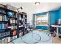 Bright office space with large window, colorful decor, and ample shelving for storage at 10288 Olathe Way, Commerce City, CO 80022