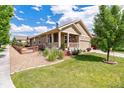 Side view of a lovely home with well-manicured landscaping and stone accents on the exterior at 10288 Olathe Way, Commerce City, CO 80022