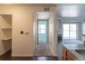 Hallway leading to a living room with a fireplace and a sliding door to a balcony at 12158 W Dorado Pl # 204, Littleton, CO 80127