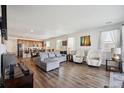 Spacious living room featuring hardwood floors, ample natural light, and modern decor at 27957 E 9Th Dr, Aurora, CO 80018