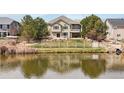 Back of house view showcasing the waterfront backyard and patio area at 1738 Edgewater Pl, Longmont, CO 80504