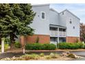 Building exterior features brick accents, private balconies, beautiful landscaping, and a welcoming ambiance at 7665 E Eastman Ave # 202A, Denver, CO 80231