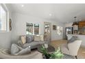 Bright living room featuring a comfy sofa and accent chairs at 3756 Decatur St, Denver, CO 80211