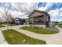 A serene street view showcases the homes and sidewalks within this quiet residential neighborhood at 10595 Boston St, Commerce City, CO 80640